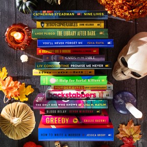 Stack of 15 Bantam Halloween books surrounded by fall leaves and candles