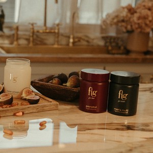 FIG Wellness prenatal vitamin jars on a kitchen counter