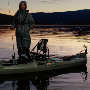 Angler standing on a Native kayak with a Newport electric kayak motor at dusk